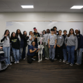 Students posing next to skeleton for Physical Therapy workshop