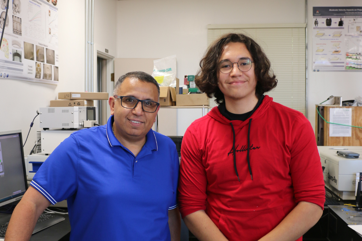 Professor George Youssef posting with 2024 YEE Scholar and 2023 SDSU Talent Search Robotics Camps participants in the Experimental Mechanics Laboratory 