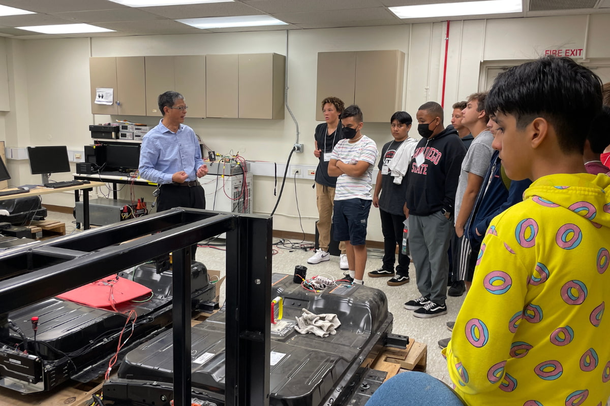 Students visiting Dr. Chris Mi's engineering lab.